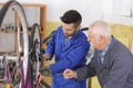 Man bicycle mechanic repairing bicycles Royalty Free Stock Photo