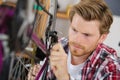 Man bicycle mechanic repairing bicycles Royalty Free Stock Photo