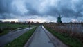 Man on bicycle next to windmill at Zaanse Schans, Netherlands