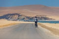 Man on bicycle, Paracas National Reserve desert, Pisco, Peru 2019-12-05.