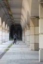 Man with bicycle standing under a bridge Royalty Free Stock Photo