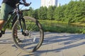 A man on a bicycle. Bicycle wheels close-up. The foot is on the bicycle pedal. Active summer. Blurred focus Royalty Free Stock Photo