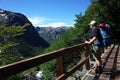 Man with big backpack standing on bridge with green mountain view in Nahuel Huapi national park, Hiking Royalty Free Stock Photo