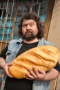 Man with big bread Royalty Free Stock Photo