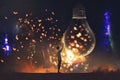 Man and big bulb with glowing butterflies inside