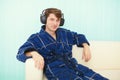 Man in big ear-phones sits on sofa Royalty Free Stock Photo