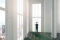 Man in big light loft room with city view and wooden flo