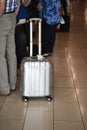 A man with a big silver suitcase on wheels in anticipation of boarding the plane. Blurry Royalty Free Stock Photo