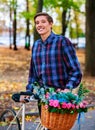 Man on bike with flowers basket in park