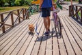 Man on bike in park in the company of his dog. Royalty Free Stock Photo