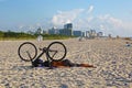 Man with bike sleeping on the beach