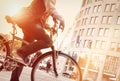 Man on bike in traffic with sunflare Royalty Free Stock Photo
