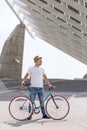 Man with bike under modern structure