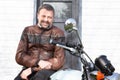 Man biker hipster portrait handsome bearded rider sit on motorcycle neoretro classic bike