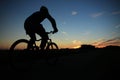 The man is biking at sunset. Royalty Free Stock Photo