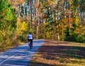 Man Biking on Trail in Autumn