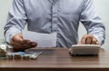 Man with bill and stack of coin on business office table vintage Royalty Free Stock Photo