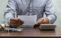 Man with bill and stack of coin on business office table vintage Royalty Free Stock Photo