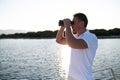 Man with binocular standing on a yacht deck Royalty Free Stock Photo