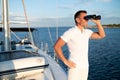 Man with binocular standing on a yacht deck Royalty Free Stock Photo