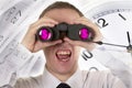 Man with binoculars observing and Clocks with calendar Royalty Free Stock Photo