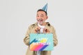 Man with birthday hat holding gift bag Royalty Free Stock Photo