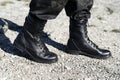 Man in black army boots with laces and khaki pants Royalty Free Stock Photo