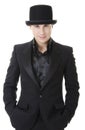 Man in black austere suit and hat Royalty Free Stock Photo