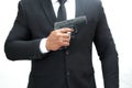 A man in a black bodyguard suit is holding a pistol at chest level ready to keep the VIPs safe. White background isolate