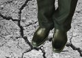 Man in black business pant and lather shoe on dirt ground