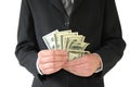 Man in black business suit, holding cash in hands