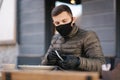 Man in black face mask sitting in cafe and prepared for eating vegan salad. Quarantine cafe concept. Covid-19 Royalty Free Stock Photo