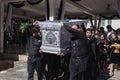 Man in black is helping to carry the coffin of the deceased into the crematorium for cremation