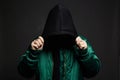 Man in Black Hood and green bomber jacket. Boy in a hooded sweatshirt Royalty Free Stock Photo