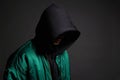 Man in Black Hood and green bomber jacket. Boy in a hooded sweatshirt Royalty Free Stock Photo