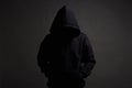 Man in Black Hood posing in dark studio. Boy Royalty Free Stock Photo