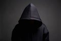 Man in Black Hood posing in dark studio. Boy in a hooded sweatshirt Royalty Free Stock Photo