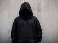 Man in a black hoodie that hides his face. The concept of a criminal. AI Generated