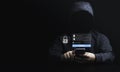 Man in black hoodie using smartphone and try to to unlock password for hacker in computer security system and financial technology