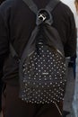 Man with black leather backpack with silver studs before Cristiano Burani fashion show, Milan Fashion Week