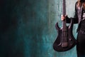 Man in black leather holding a guitar. Rocker and metalhead, youth style, music. Textured background, place for text Royalty Free Stock Photo