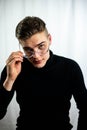 a man in black shirt with glasses on his face looking up Royalty Free Stock Photo