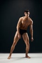 man in black shorts with a pumped body on a dark background model