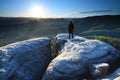 Man in black stay at the end of cracked rocky cliff