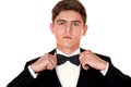 Man in a black suit adjusts his bow tie close-up Royalty Free Stock Photo