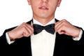 Man in a black suit adjusts his bow tie close-up face Royalty Free Stock Photo