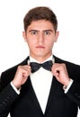 Man in a black suit adjusts his bow tie Royalty Free Stock Photo