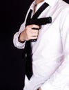 Man in black suit holding gun in hand. Secret agent, mafia, bodyguard concept Royalty Free Stock Photo