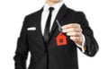 A man in a black suit holds the keys to the house. Key ring red Royalty Free Stock Photo