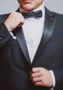 Man in black suit wearing bow tie. Male fashion. Formal suit classic style outfit. Elegant and stylish hipster.
